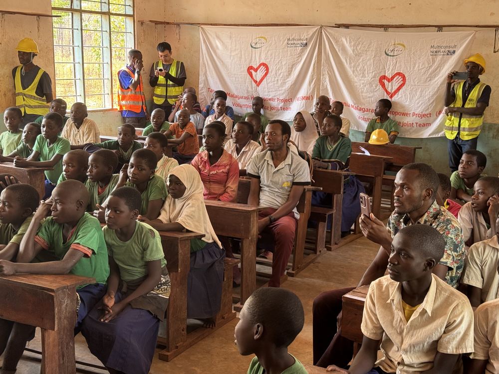 Pupils and villagers filling the classroom for the first lesson