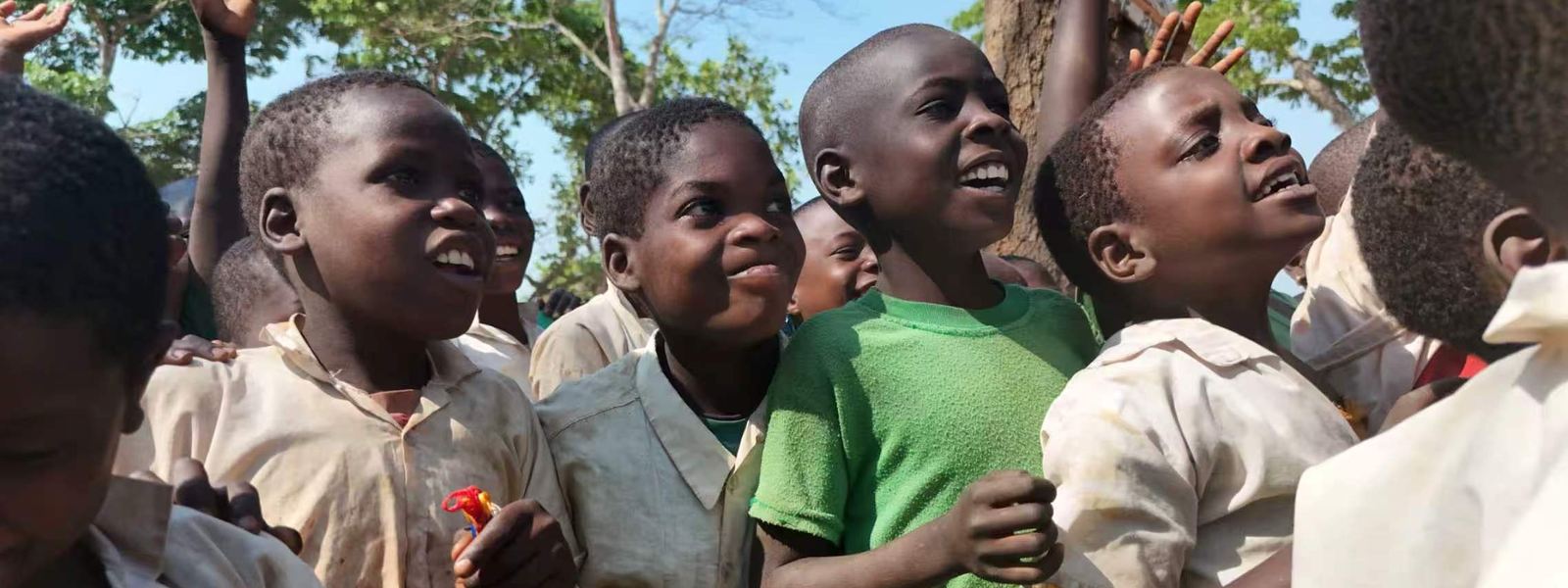 Laughing pupils crowding together outside after class