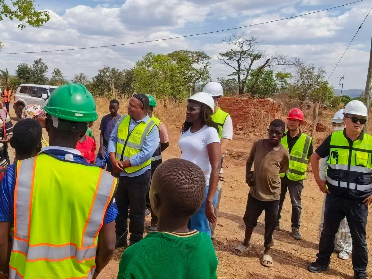 African Development Bank specialists talking with residents in the hamlet