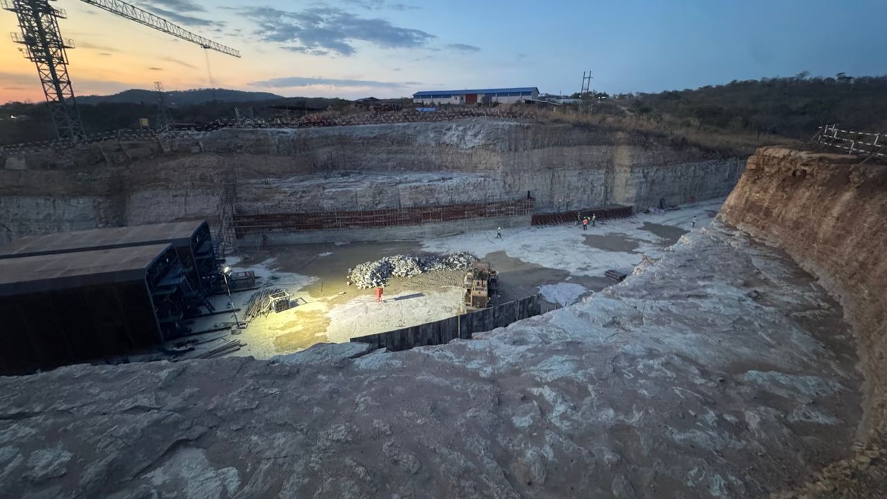 Downstream end of the headrace culvert at the surge tank at dusk, with two steel formwork trolleys