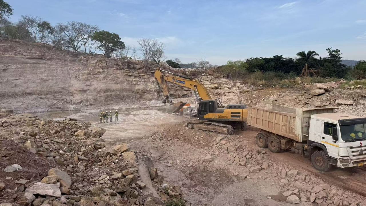 Excavator loading a dump truck in the dam foundation