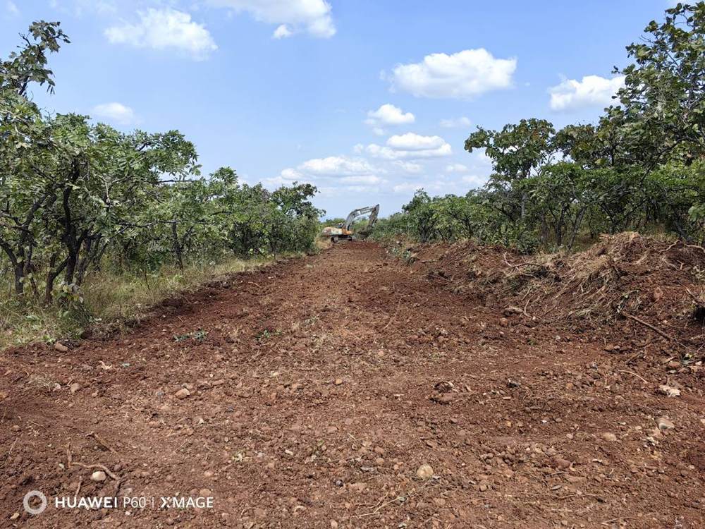Wide graded red-earth road after improvement