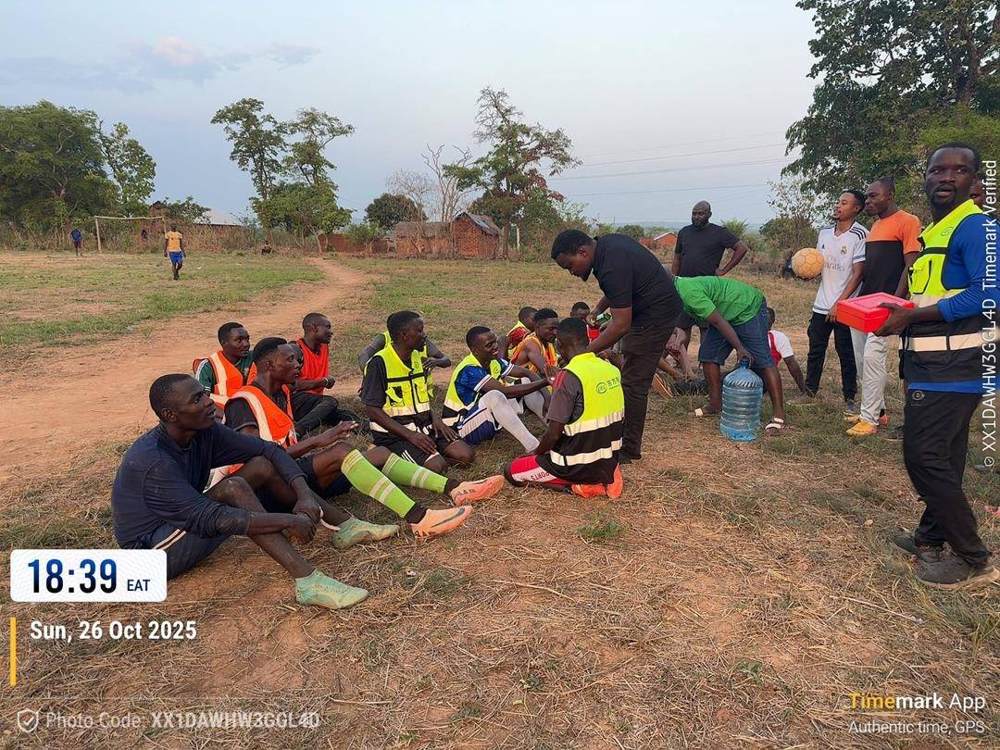 Project staff helping village players with kit