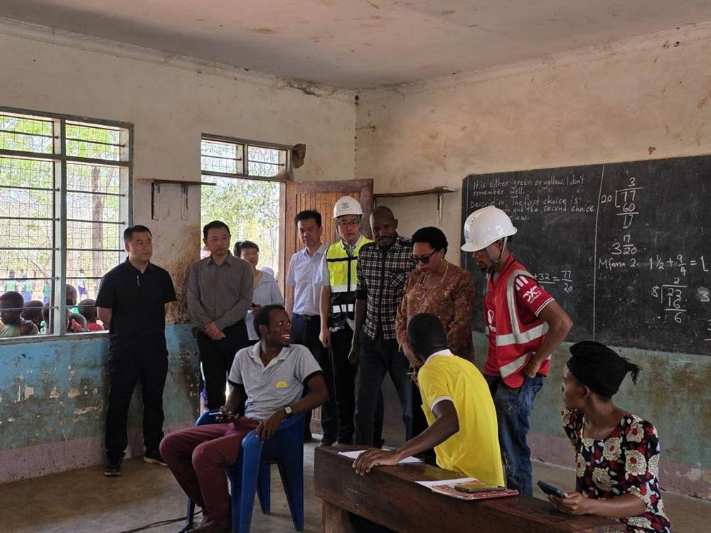 Visitors in a classroom with pupils and teacher