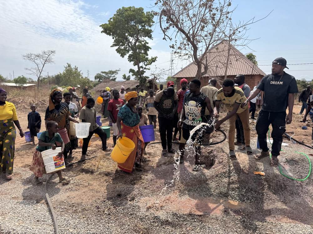 Water pouring from the new borehole outlet
